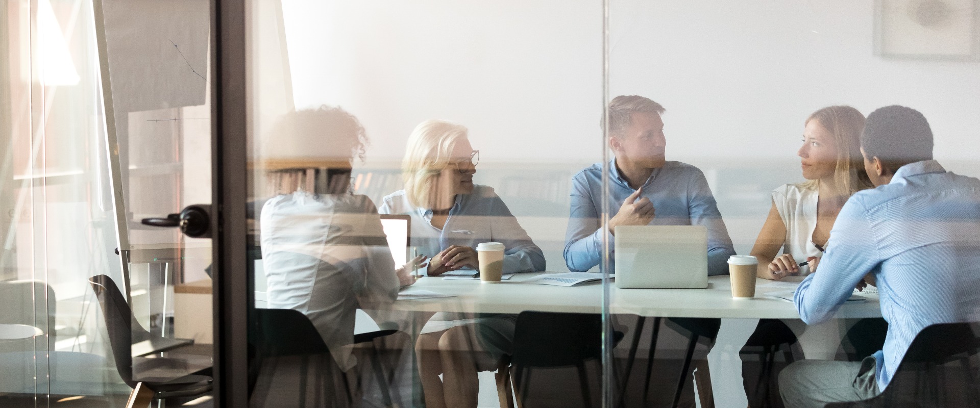 Business people negotiating at boardroom behind closed doors