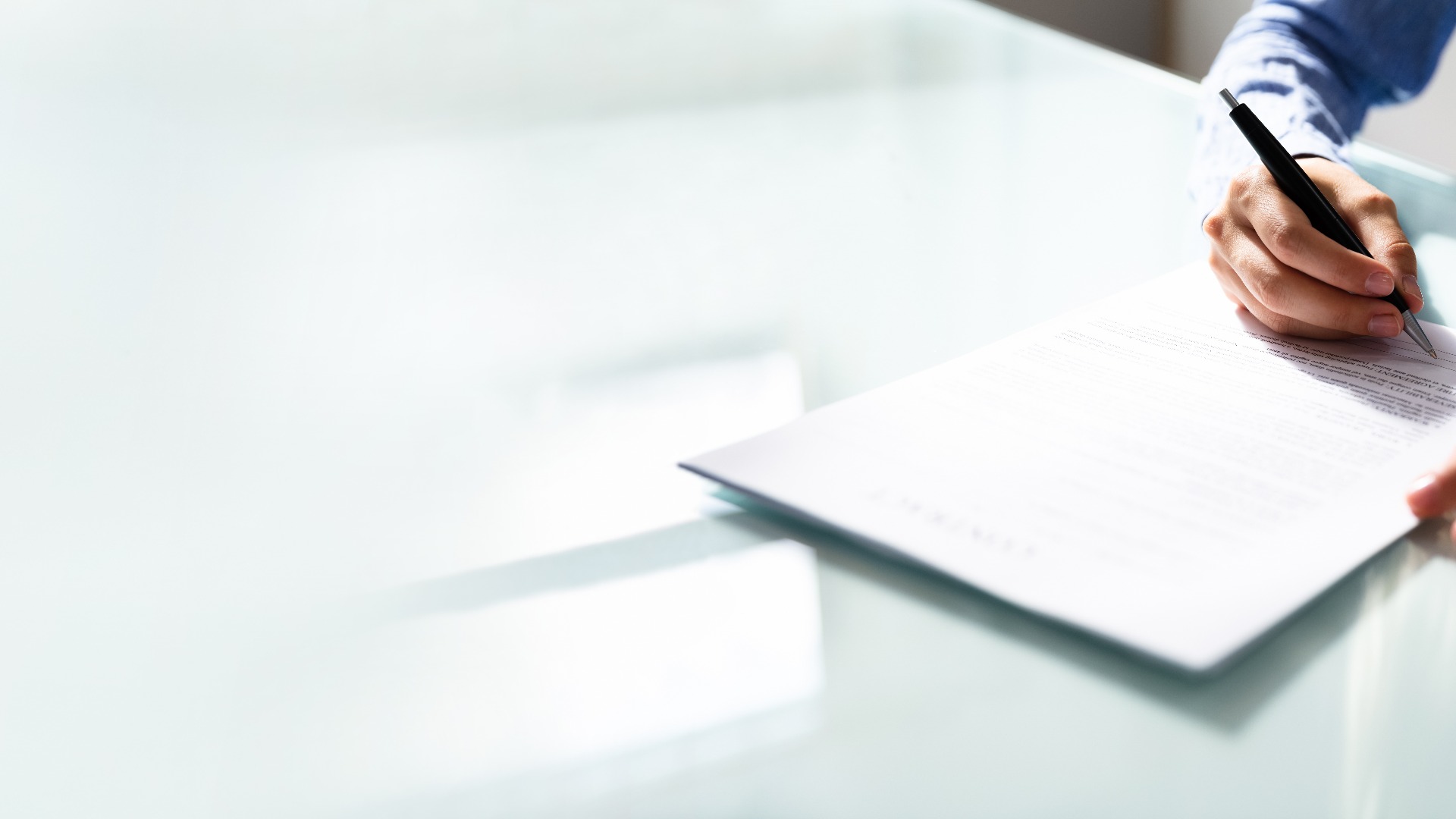 Businesswoman's Hand Signing Contract
