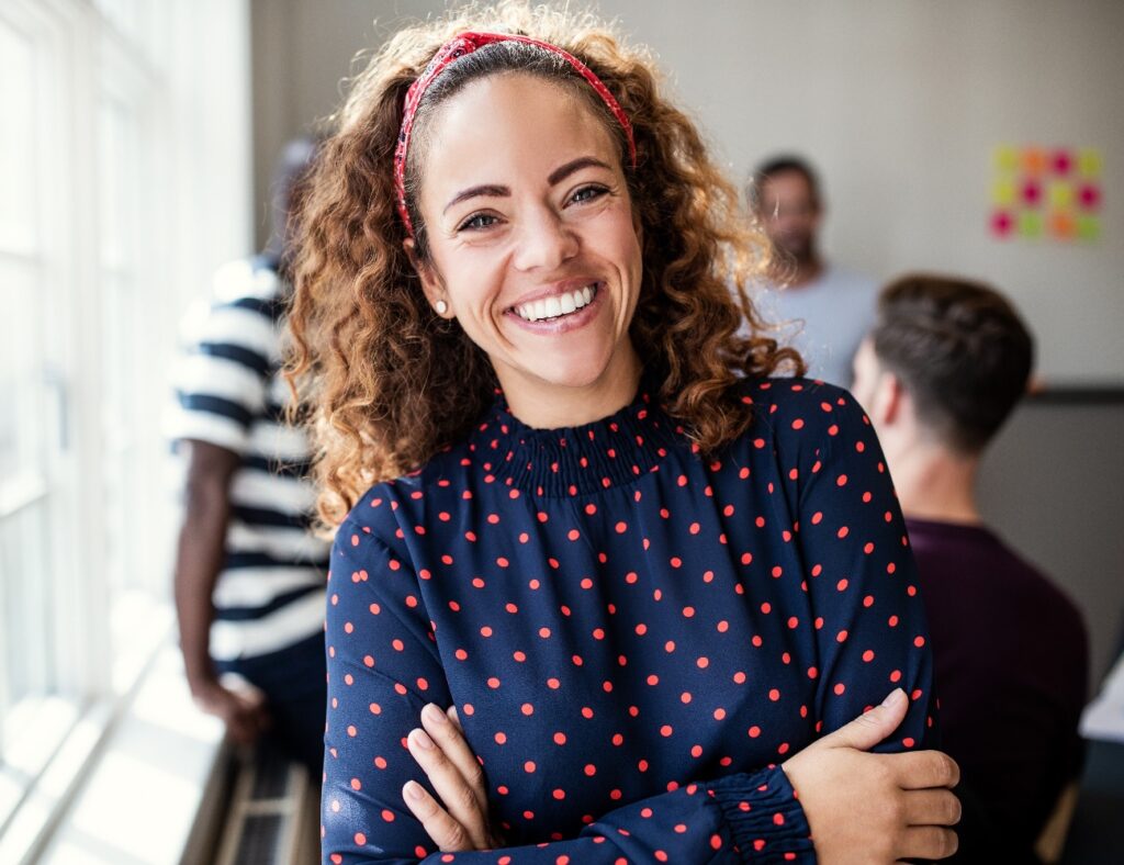 Smiling female designer standing in an modern office