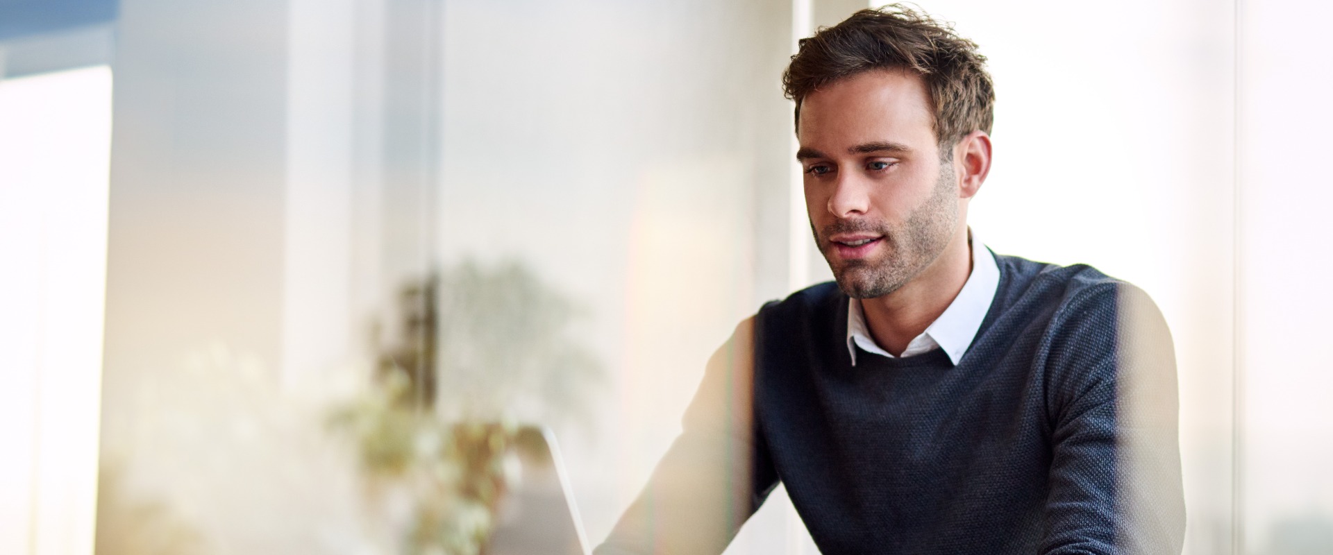Young businessman using a laptop while working from home
